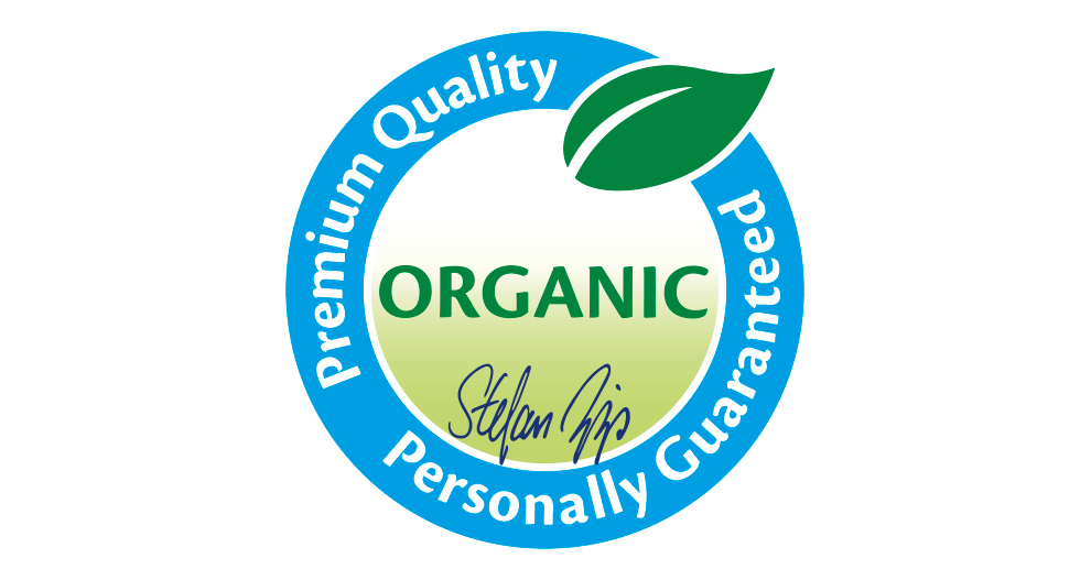 Pyöreä merkki, jonka keskellä on sana "ORGANIC", jota ympäröivät sanat "Premium Quality", "Personally Guaranteed" ja ylhäällä tyylitelty lehti.